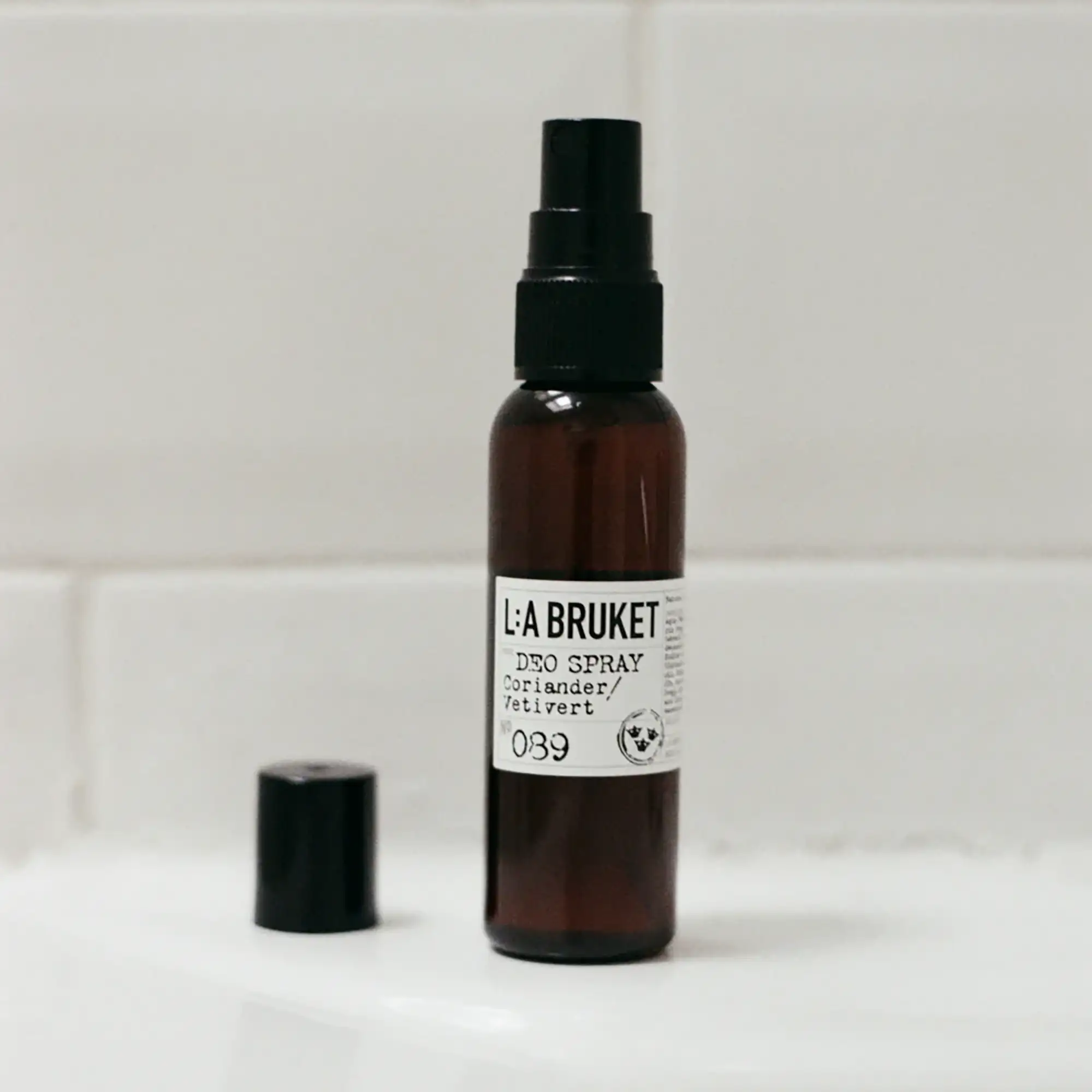 Badrumsmiljö med pumpflaska och tillhörande kork i bakgrunden.